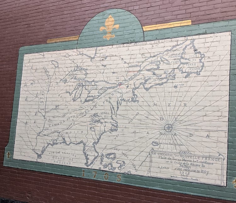 photo: old timey map of 'Le Canada Du Nouvelle France' on a brick wall from 1705